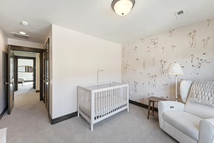 Bedroom featuring a decorative accent wall, recessed lighting, and light-toned carpeting