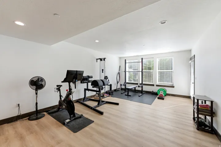 Spacious room featuring light wood-finish flooring and recessed lighting