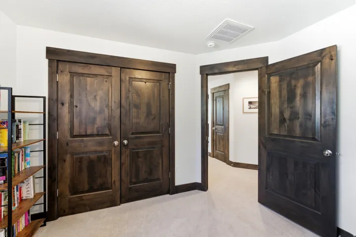 Interior space featuring dark wood-finish doors with panel details and matching trim