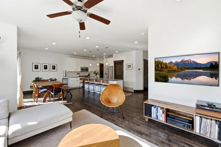 Spacious living area featuring wood-finish flooring, recessed lighting, and a ceiling fan