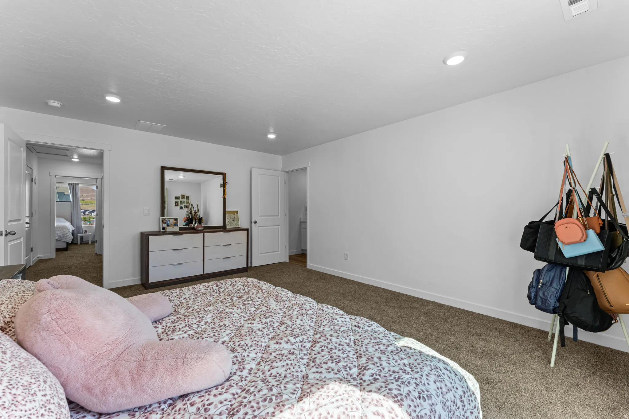 Carpeted bedroom with recessed lighting, white walls, and white trim