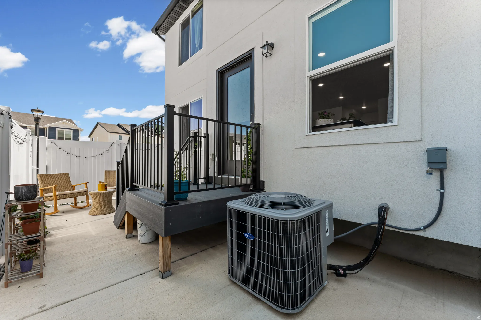 Private patio area featuring a composite deck with black railings