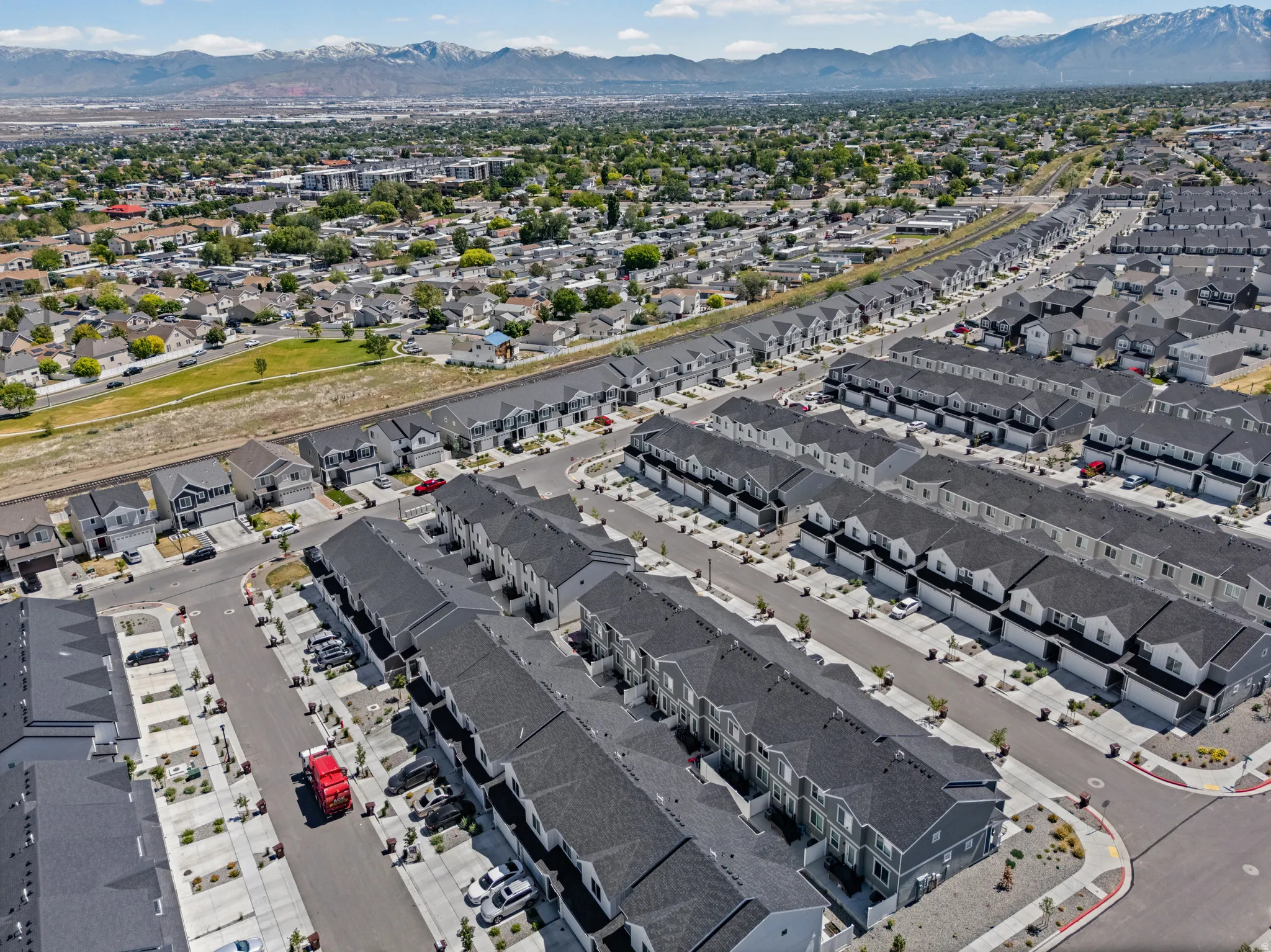 Aerial perspective showcasing a structured residential development with rows of townhomes and detached properties