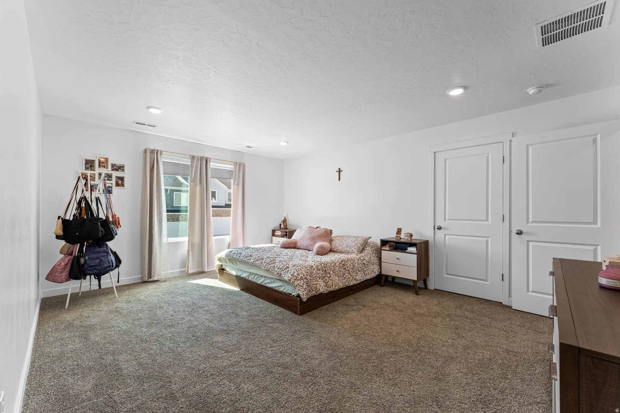 Carpeted room featuring white walls, recessed lighting, and two panel doors