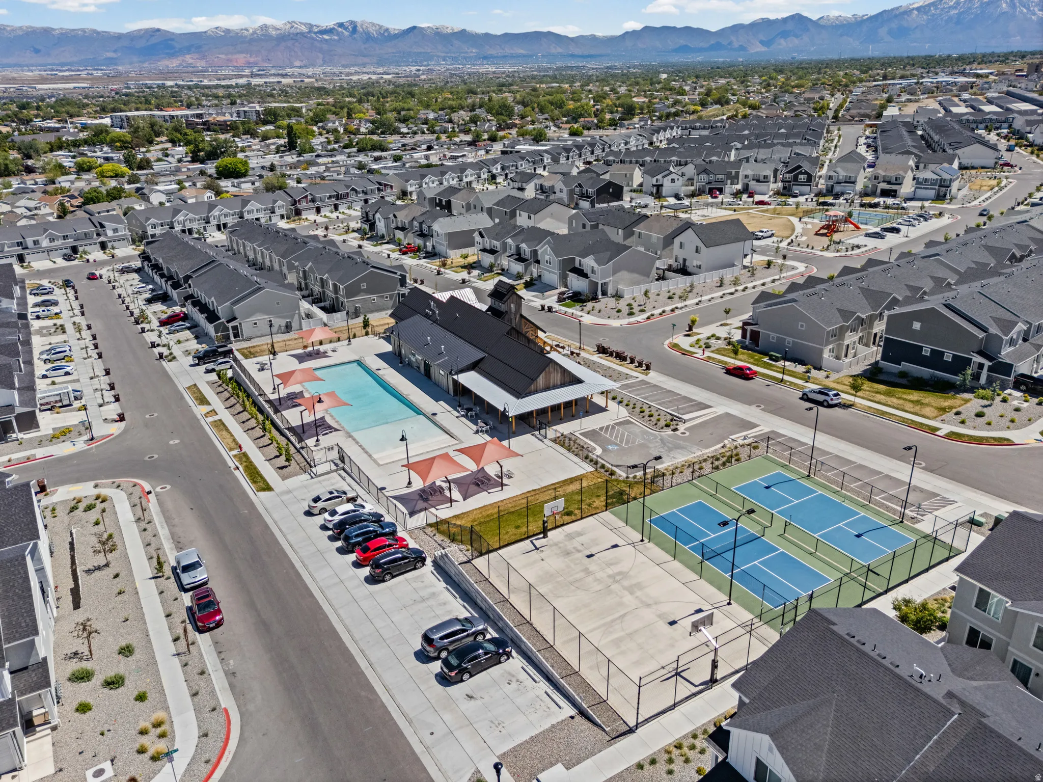 Community amenities featuring a swimming pool, clubhouse, tennis courts, basketball court, and dedicated parking