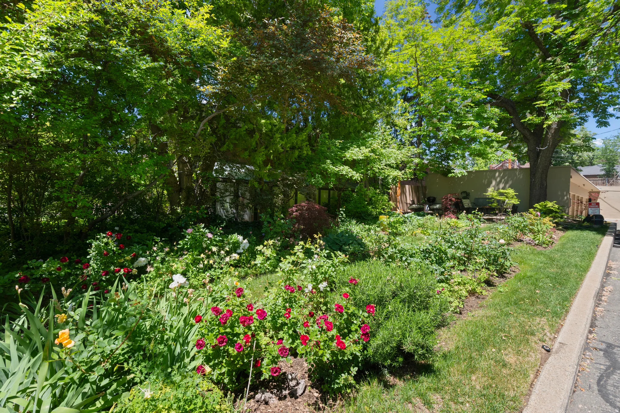 Landscaped garden bed featuring a variety of flowering plants and lush greenery