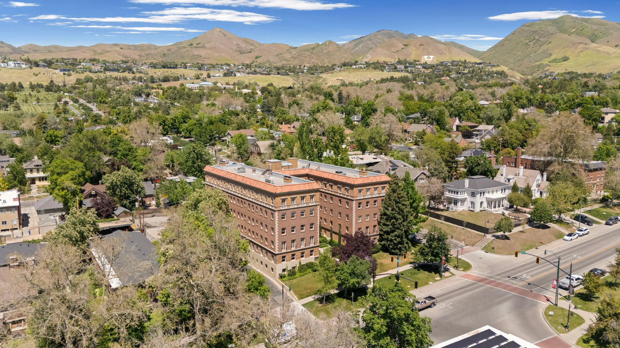 Historic multi-story building featuring brick construction and a red tile roof