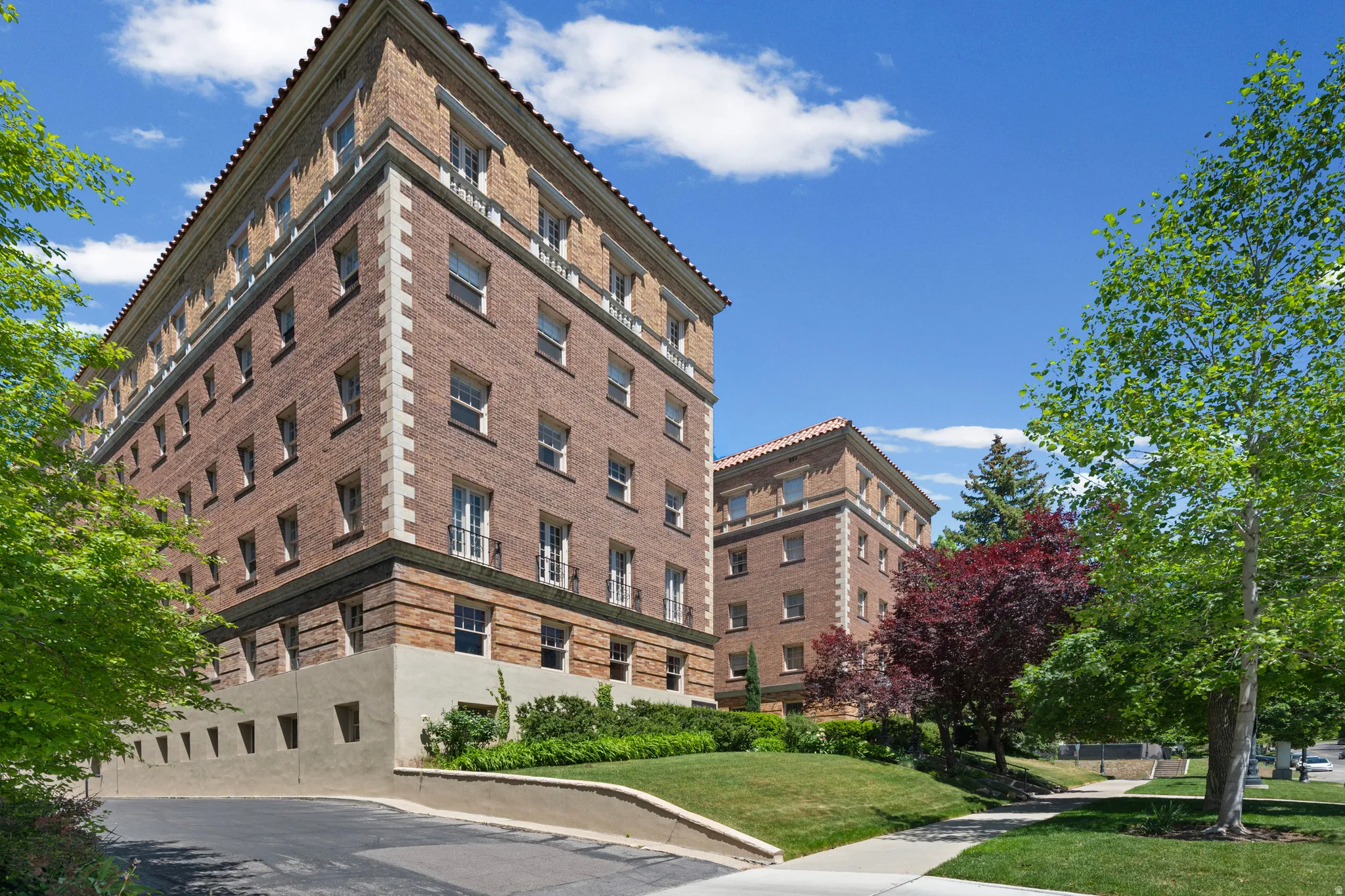 Brick exterior building with stone accents and a terracotta tile roof