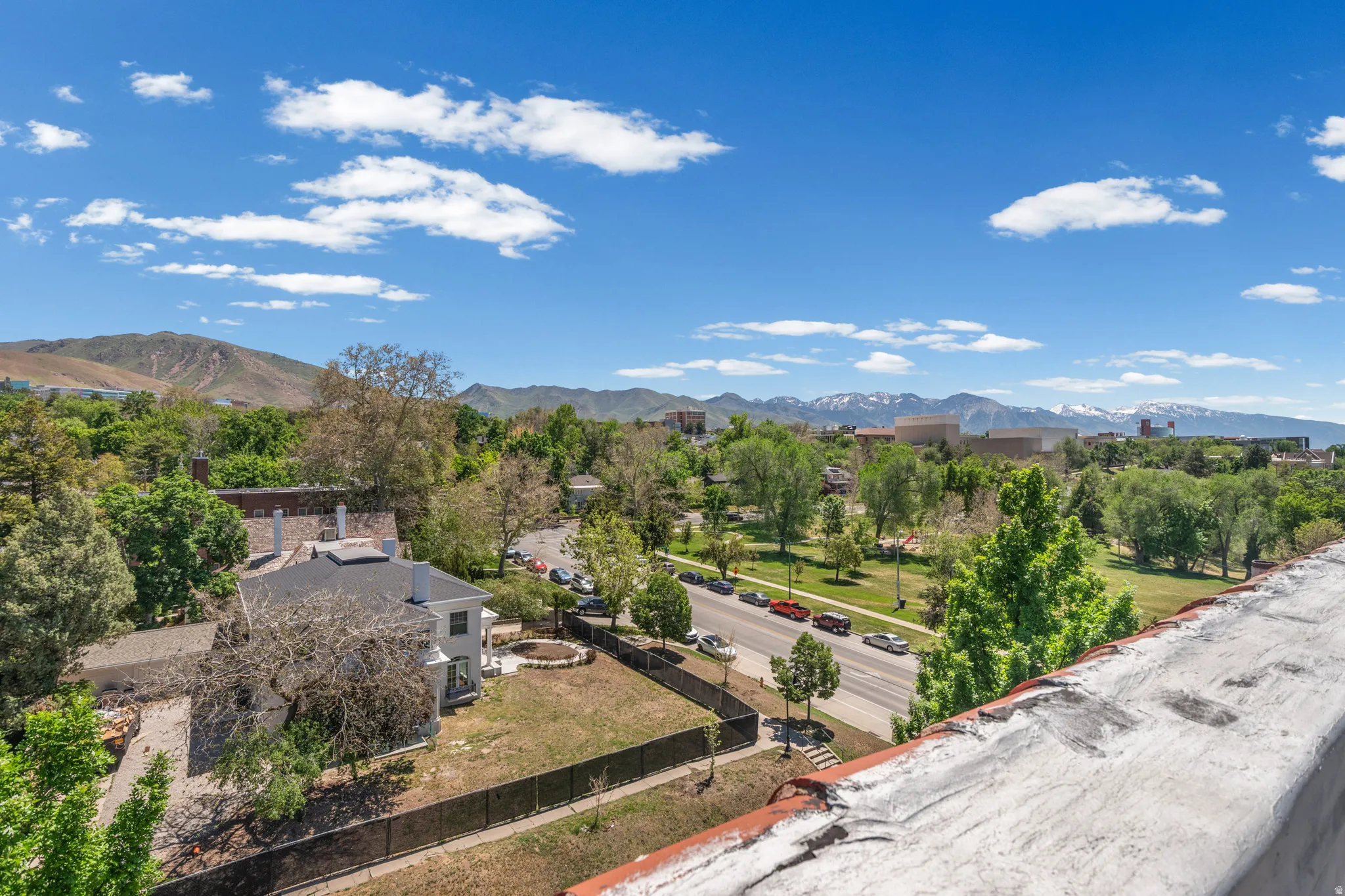 Expansive grounds with a large lawn, mature trees, and a circular hardscaped patio area