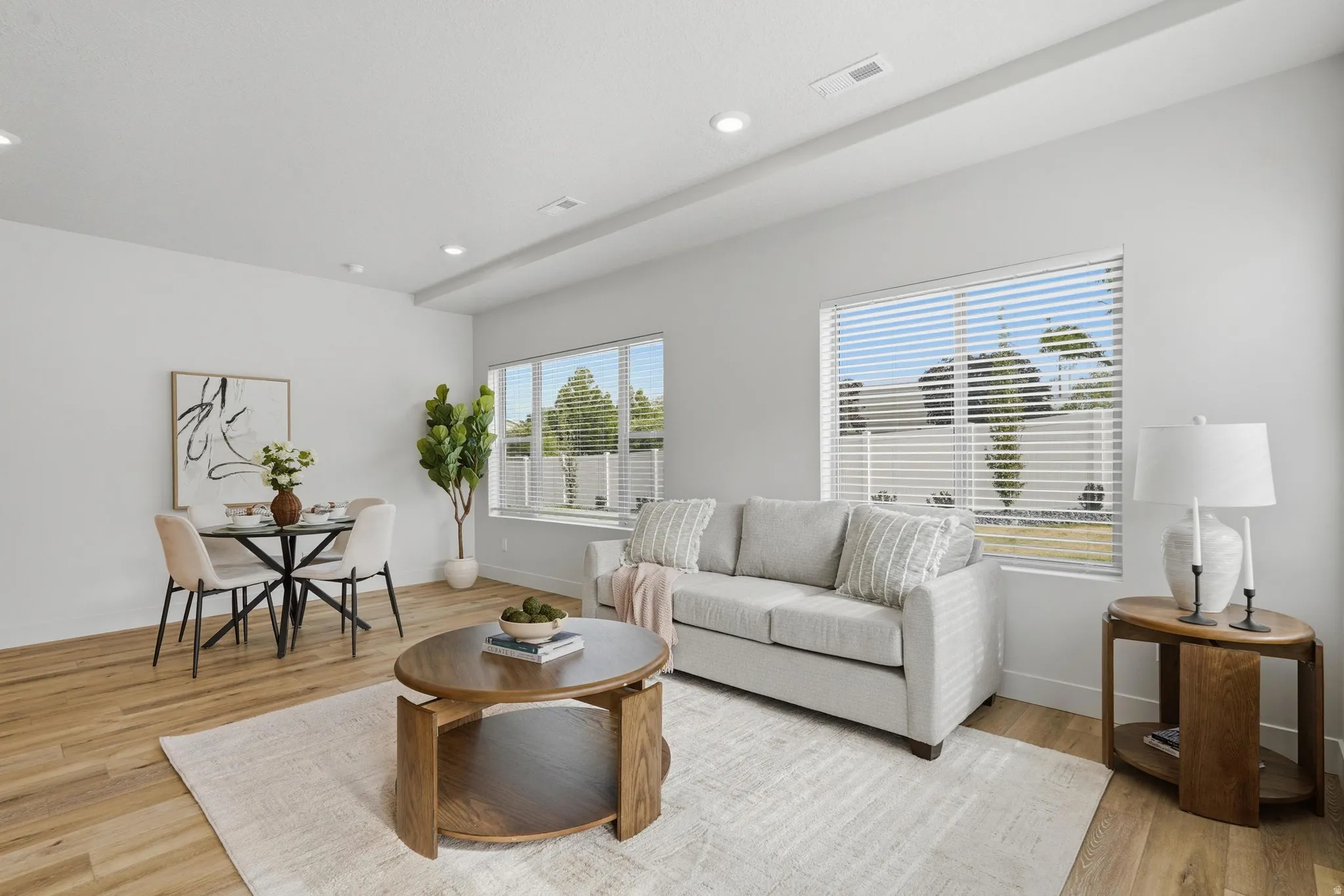 Open-concept living space with wood-finish flooring