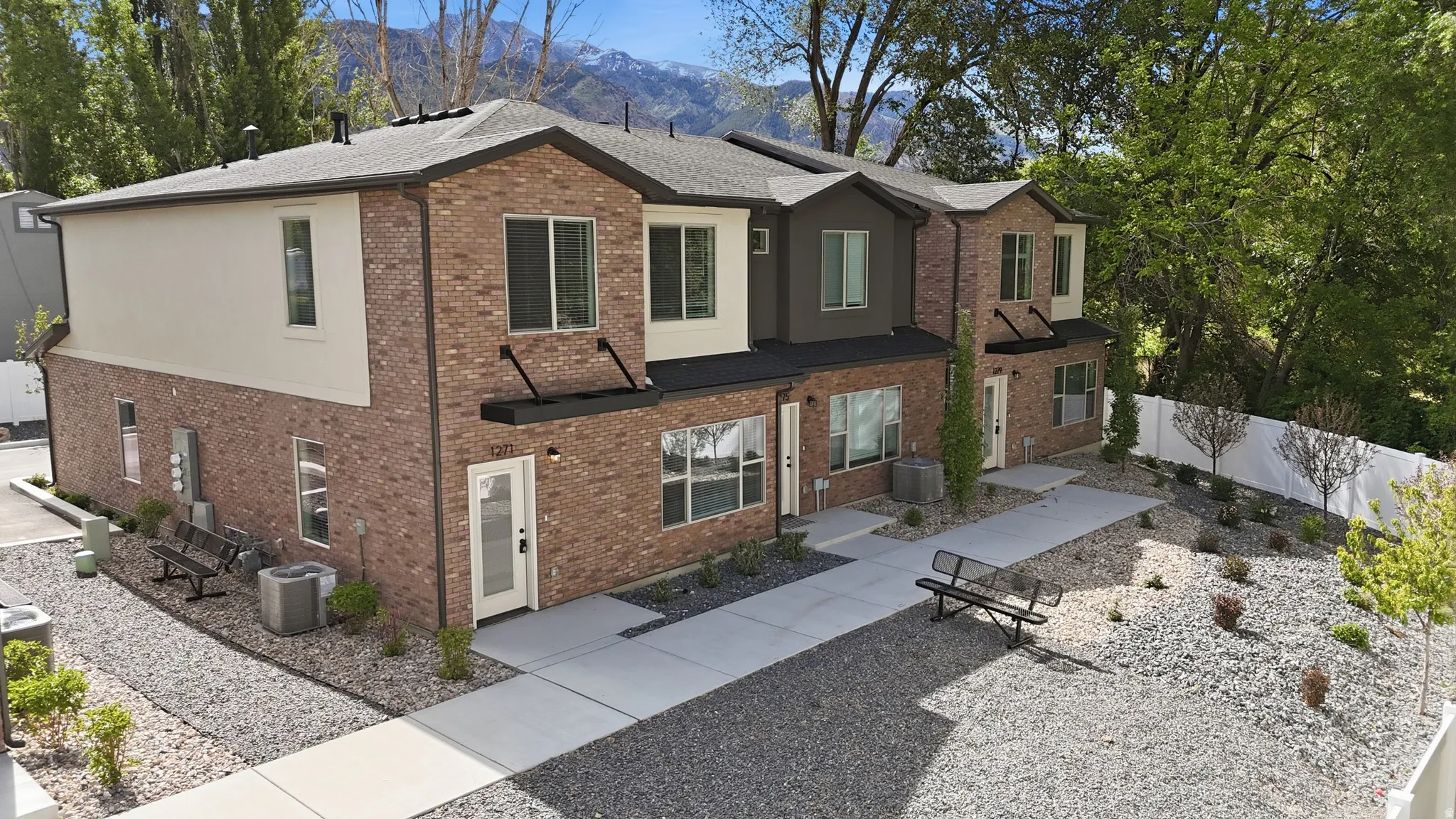Contemporary multi-story exterior featuring brick and stucco finishes