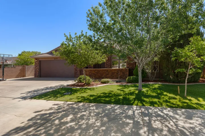 Single-story exterior with a tile roof, a two-car garage, and a concrete driveway
