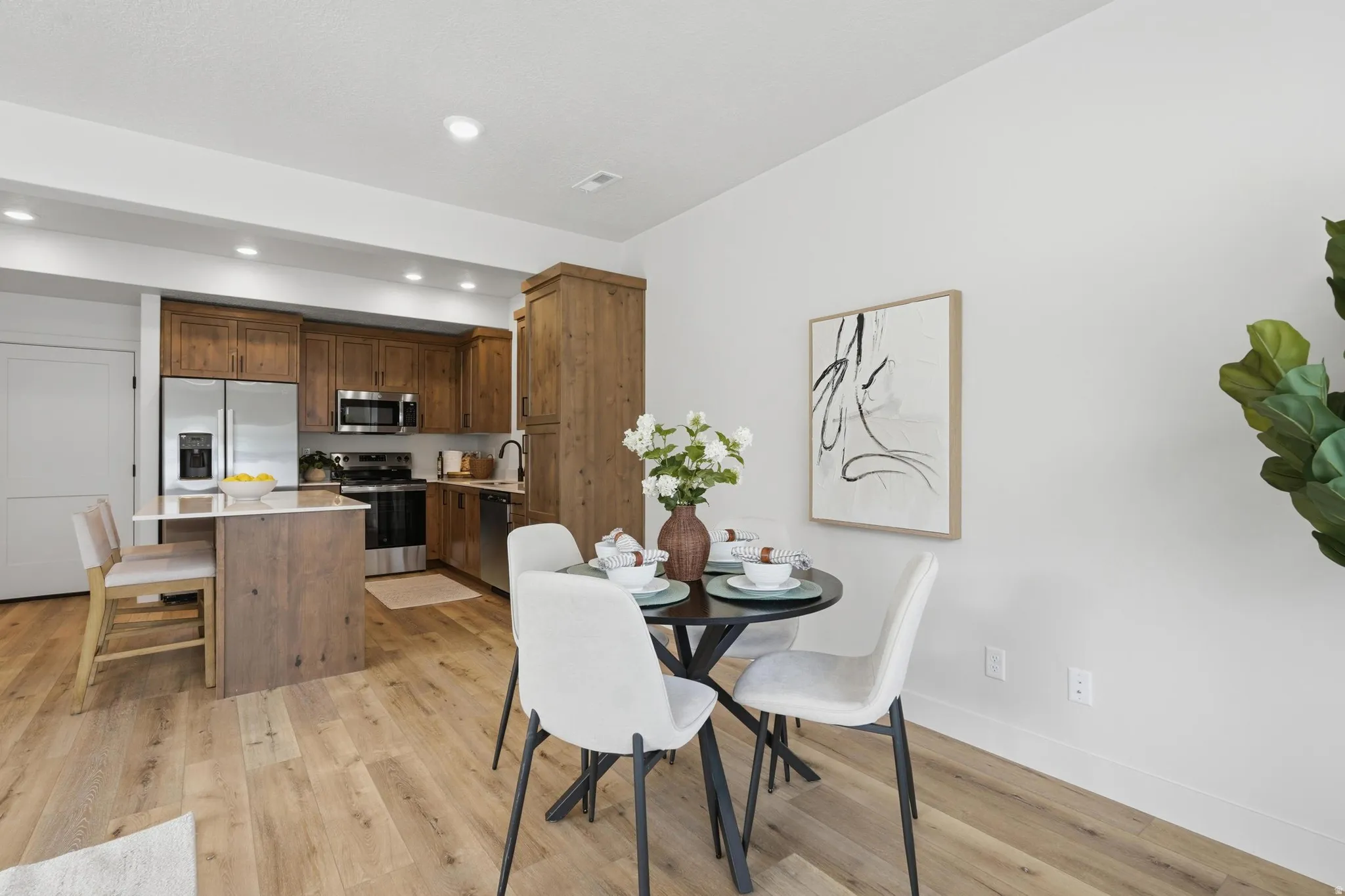 Open-concept living area with light wood-finish flooring