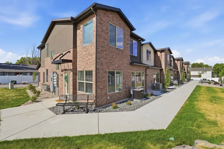 Contemporary townhome-style residences featuring brick and stucco exteriors
