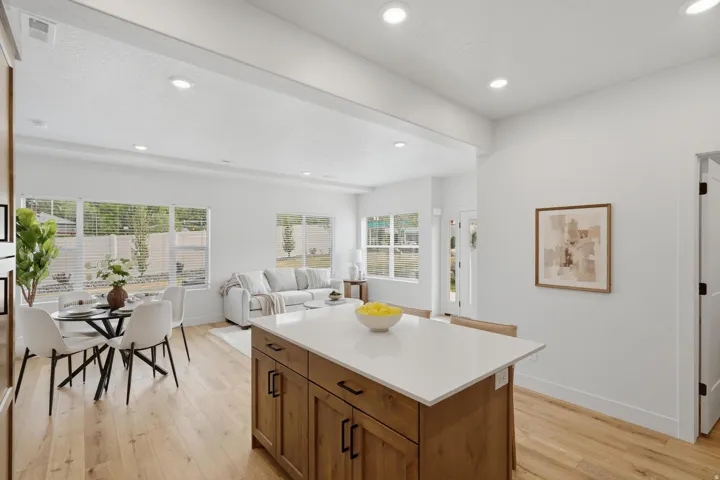 Central kitchen island with wood-finish cabinetry and a light-toned countertop