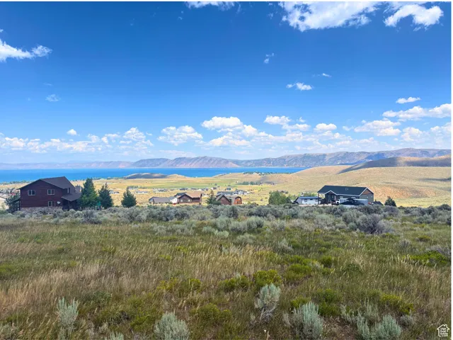 Expansive natural landscape with distant water and mountain terrain
