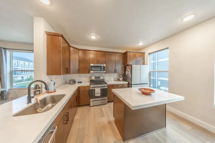 Modern kitchen featuring light wood-finish flooring and recessed lighting