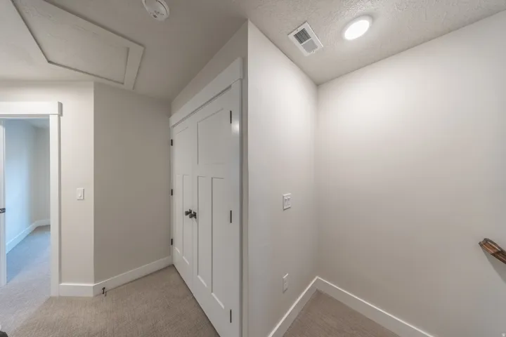 Hallway featuring light neutral wall paint, white trim, recessed lighting, and carpet flooring