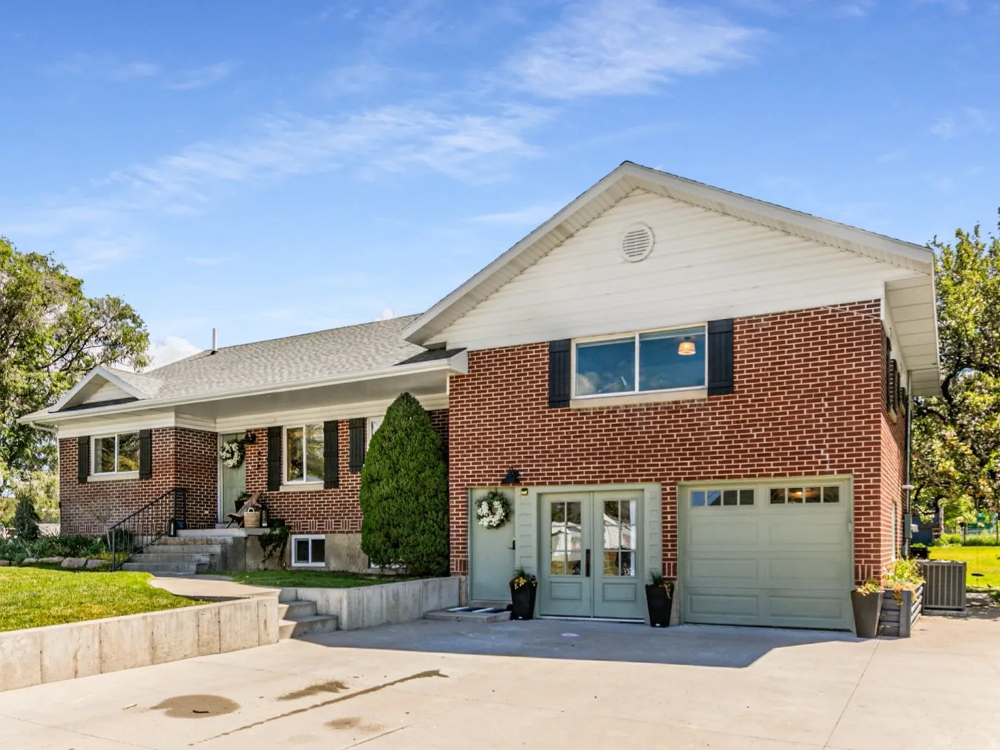 Brick exterior with white siding accents and black window shutters
