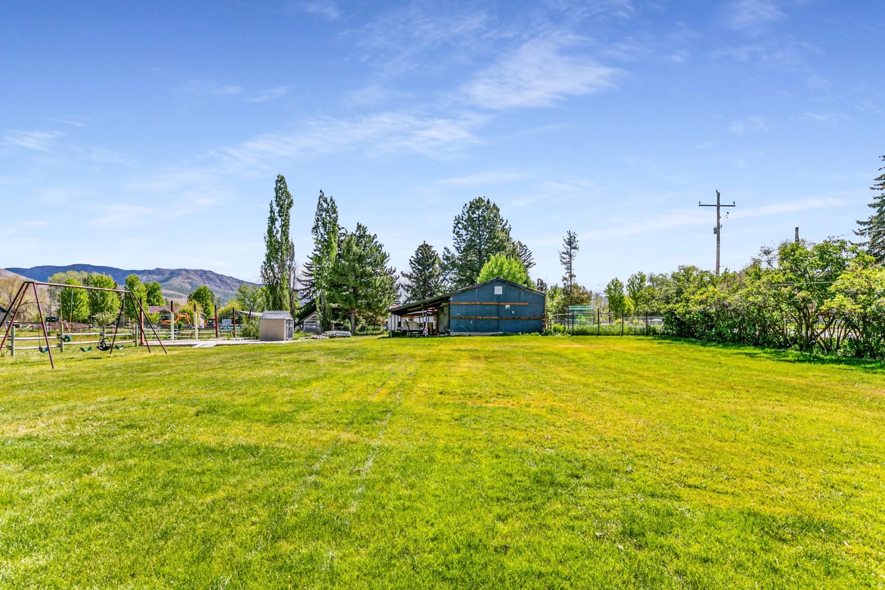 Expansive green lawn with mountain backdrop