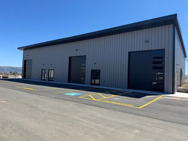 Commercial building featuring a corrugated metal exterior and a flat roofline
