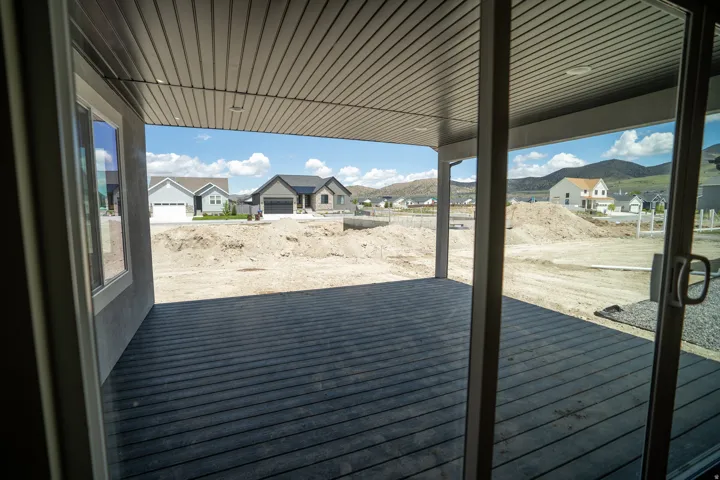 Covered patio with durable decking, overhead soffit, and recessed lighting
