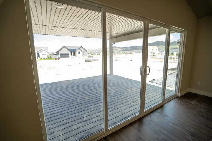 Triple-panel sliding glass door providing access to a covered patio