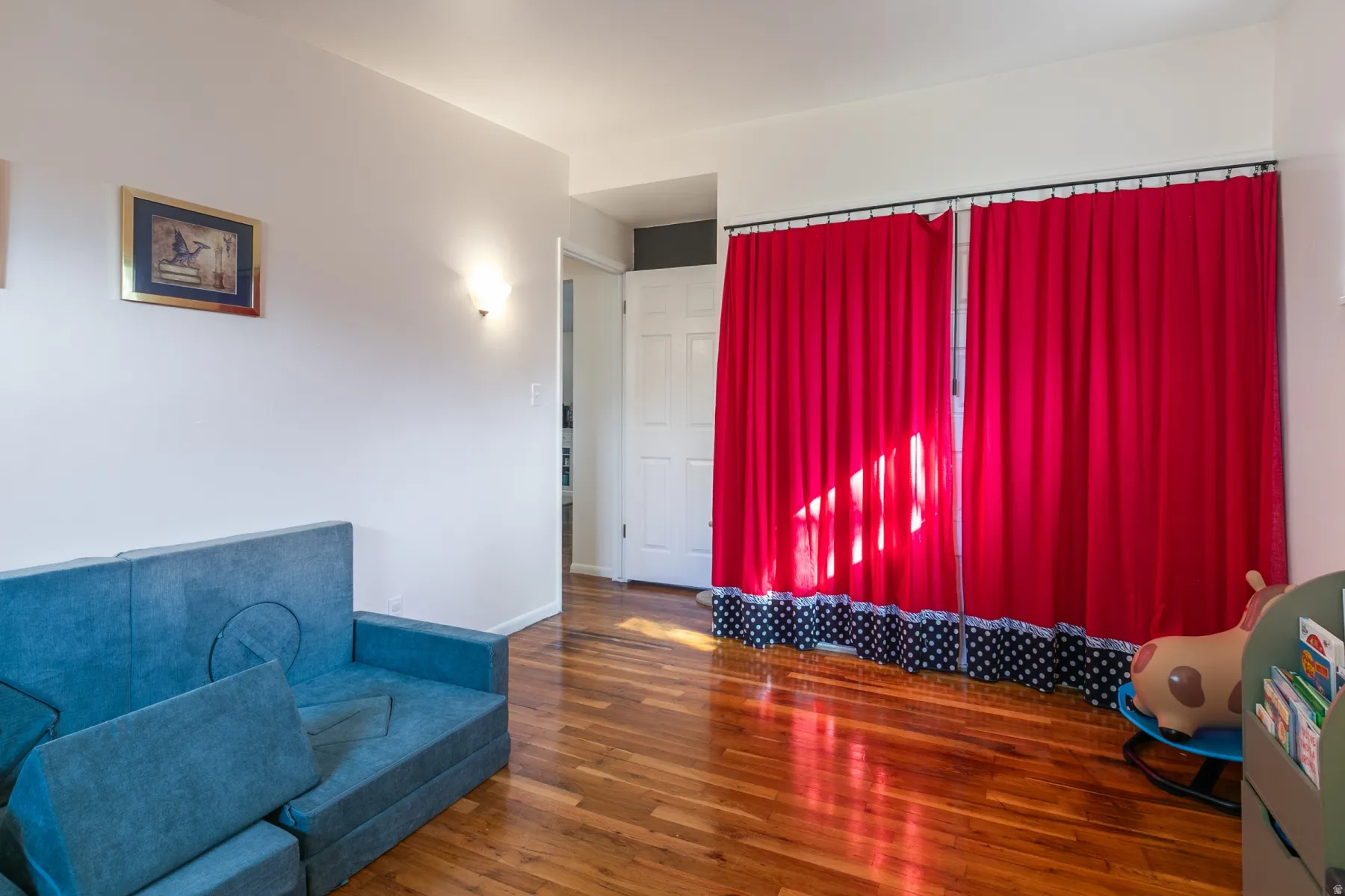 Large bedroom with hardwood flooring, large closet.