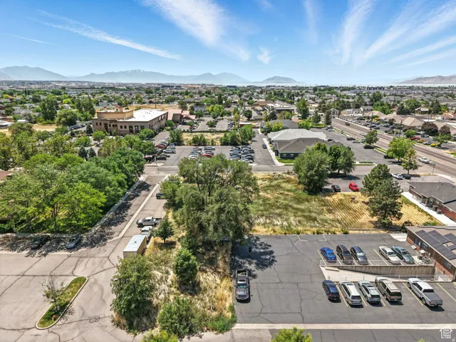 Expansive aerial perspective showcasing a developed neighborhood with distant mountain and water features