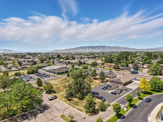 Expansive aerial perspective showcasing a significant land parcel with paved access