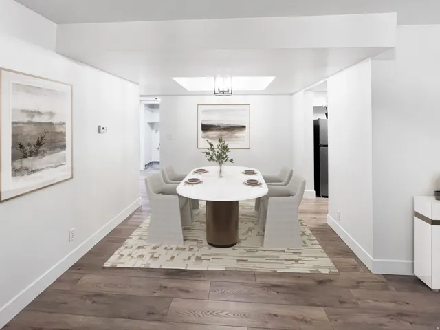 VIRTUALLY STAGED-Dining room featuring fresh wood style floors and artistic ceiling