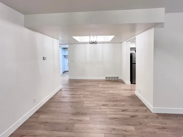 Dining room featuring fresh wood style floors and artistic ceiling
