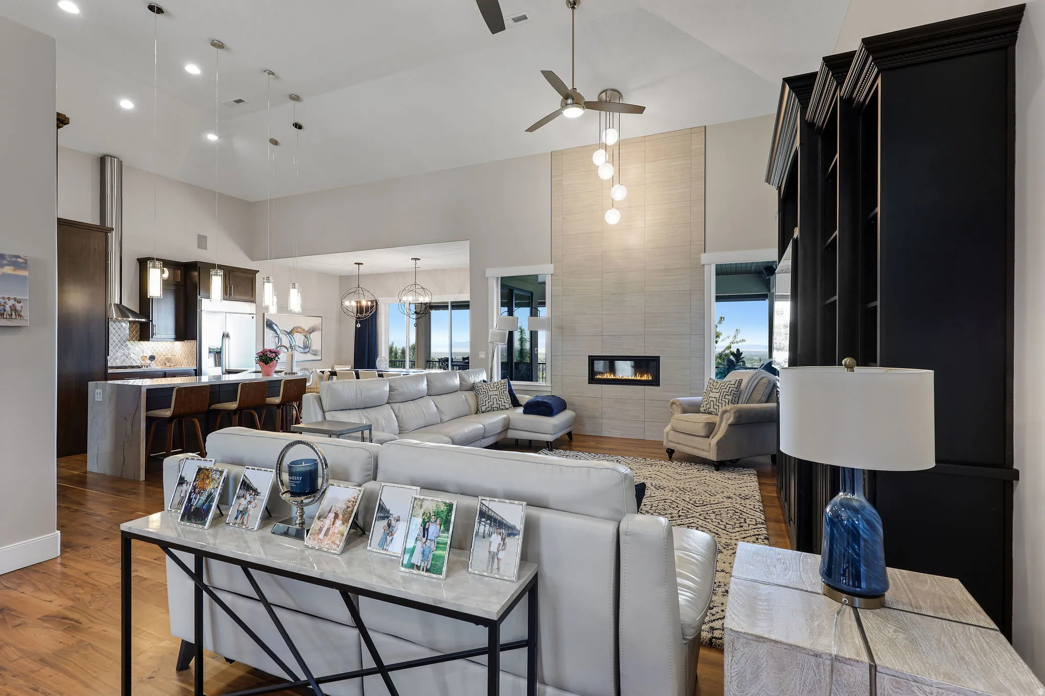 Vaulted ceilings in this open-concept living space featuring wood-finish flooring