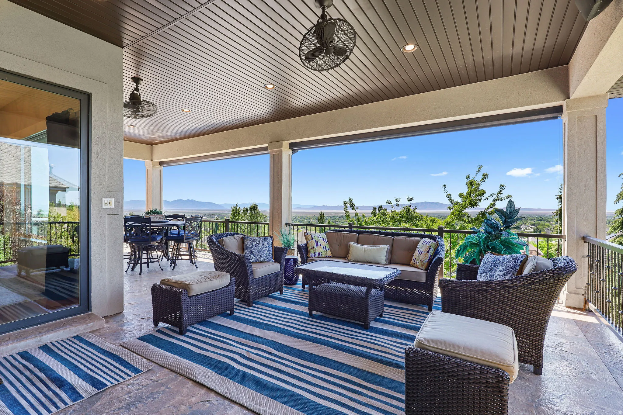 Expansive covered patio featuring a textured concrete floor and wood-finish ceiling