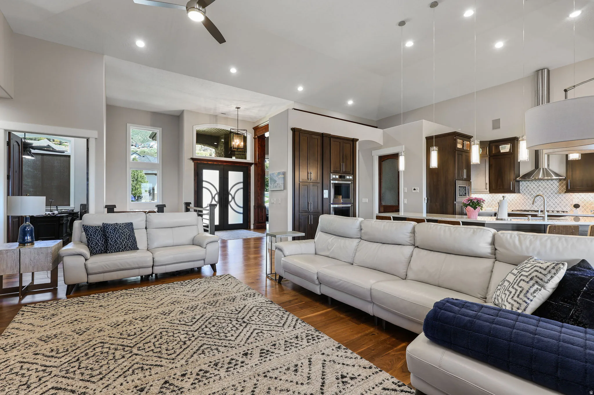 Open-concept living space featuring wood-finish flooring, recessed lighting, and a ceiling fan