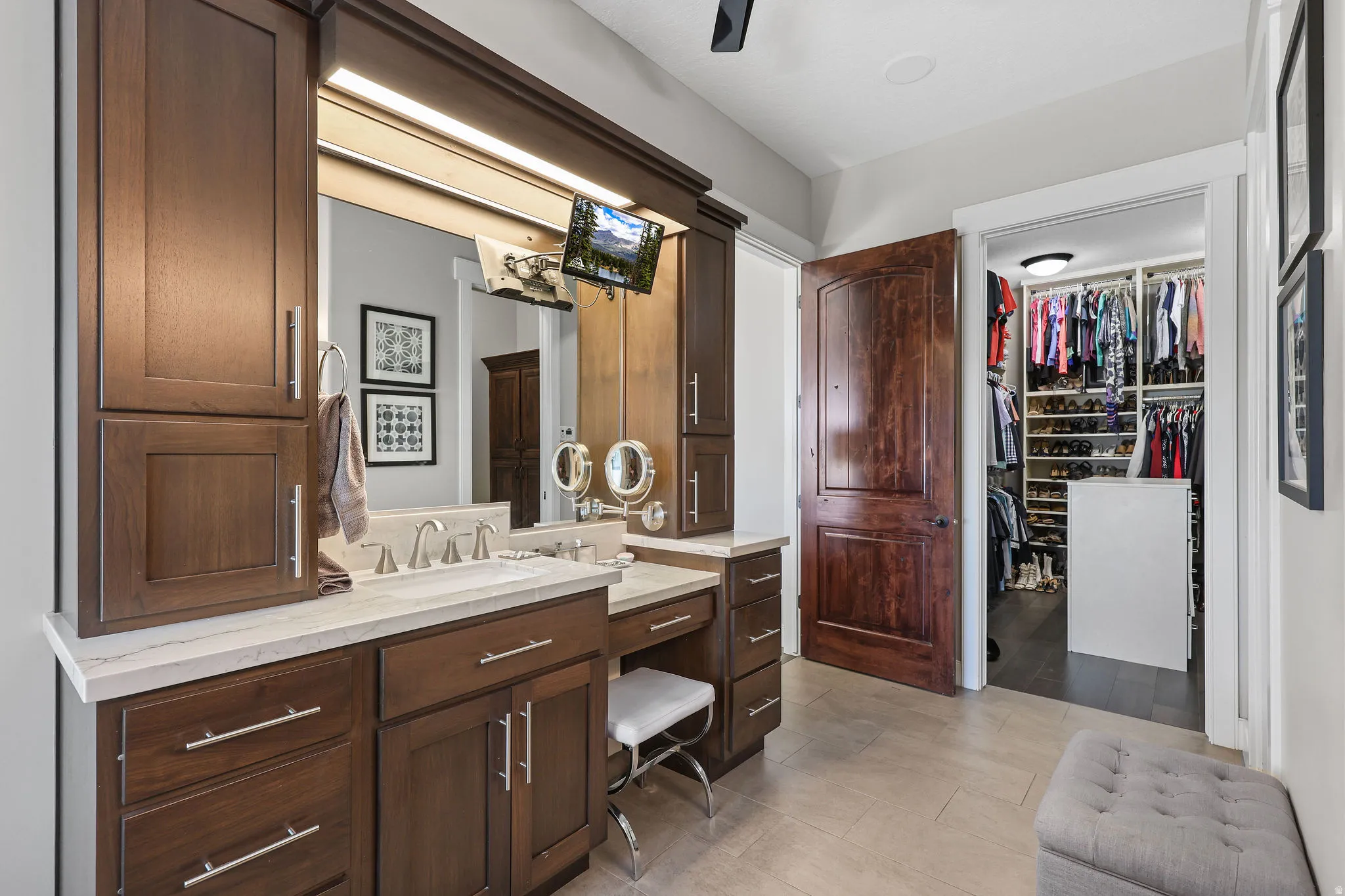 Bathroom vanity featuring dark wood cabinetry, a light-toned countertop, and dual sinks