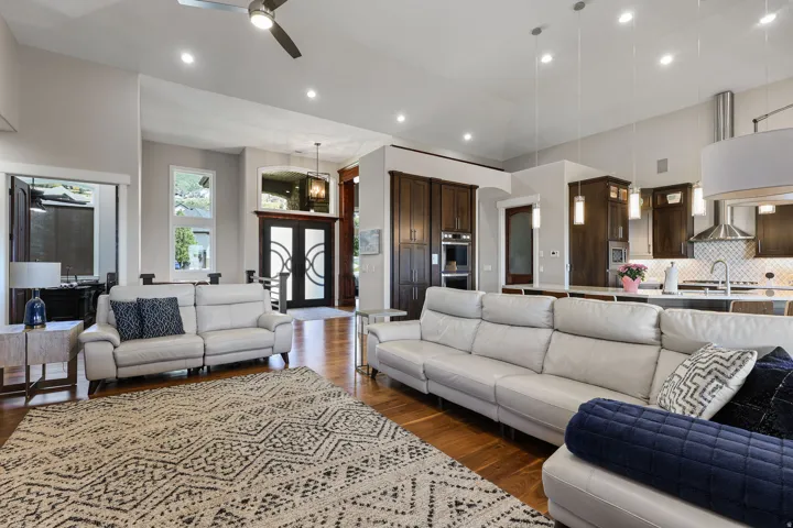 Open-concept living space featuring wood-finish flooring, recessed lighting, and a ceiling fan