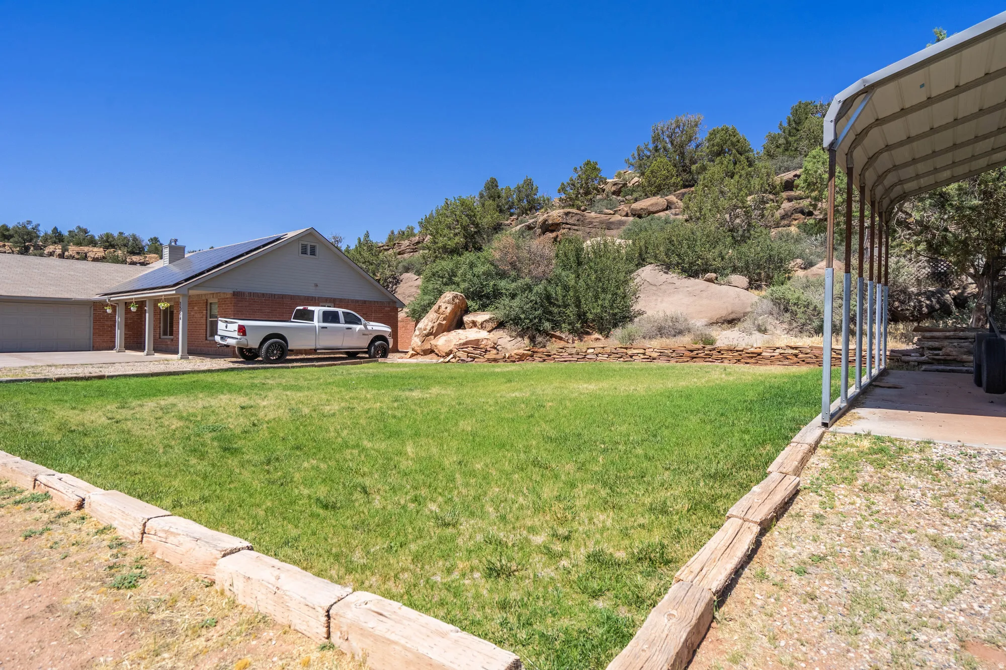 Expansive green lawn with wood-tie borders