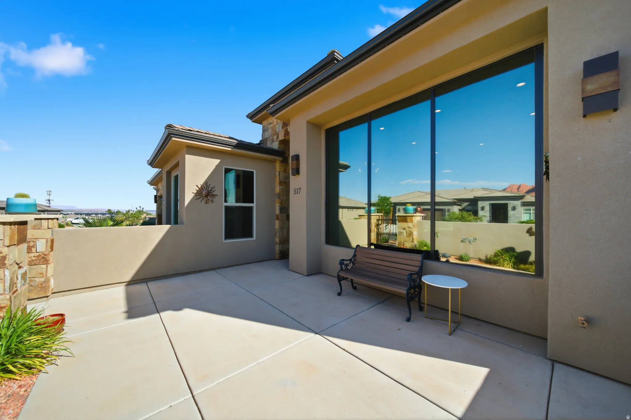 Expansive concrete patio area with a stone veneer accent wall