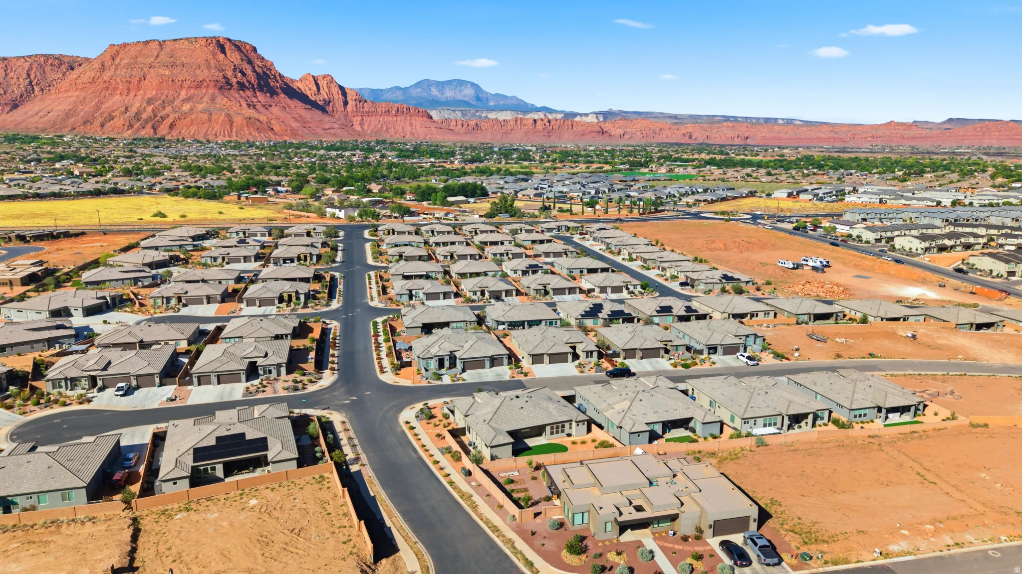 Aerial landscape featuring an organized residential development with multiple single-story homes