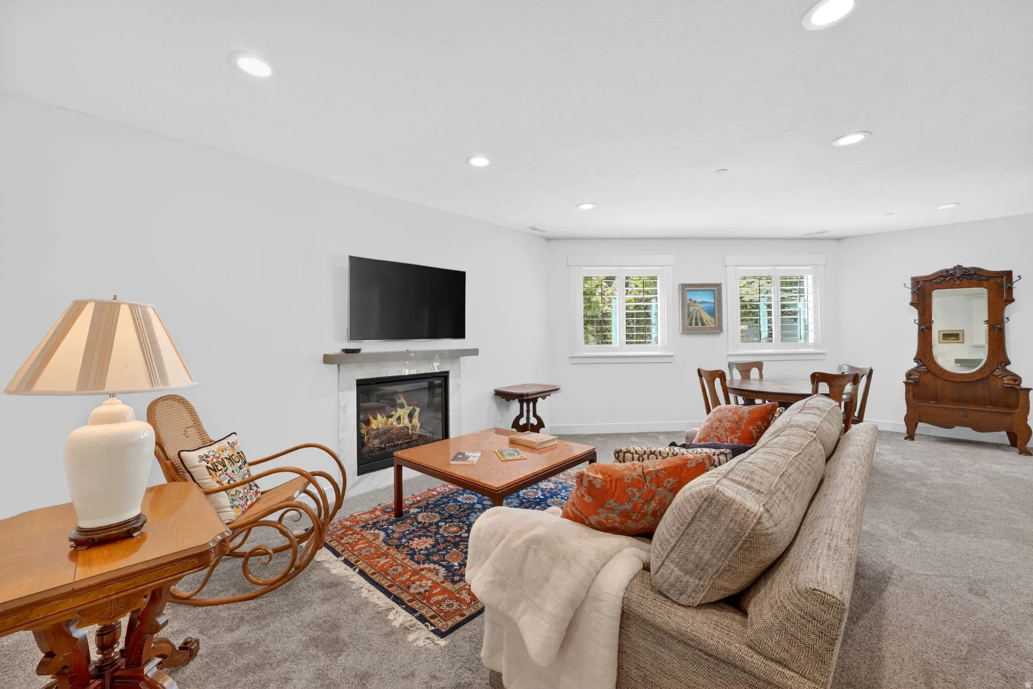 Mother in Law - Living area featuring a gas fireplace with a light-colored tile surround and a wood mantel