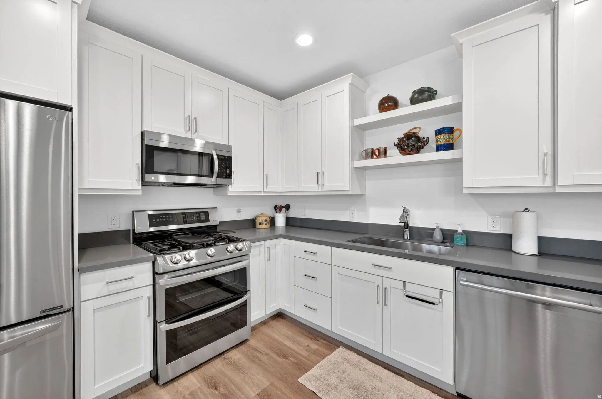 Mother in Law - Modern kitchen featuring white shaker cabinetry and stainless steel appliances