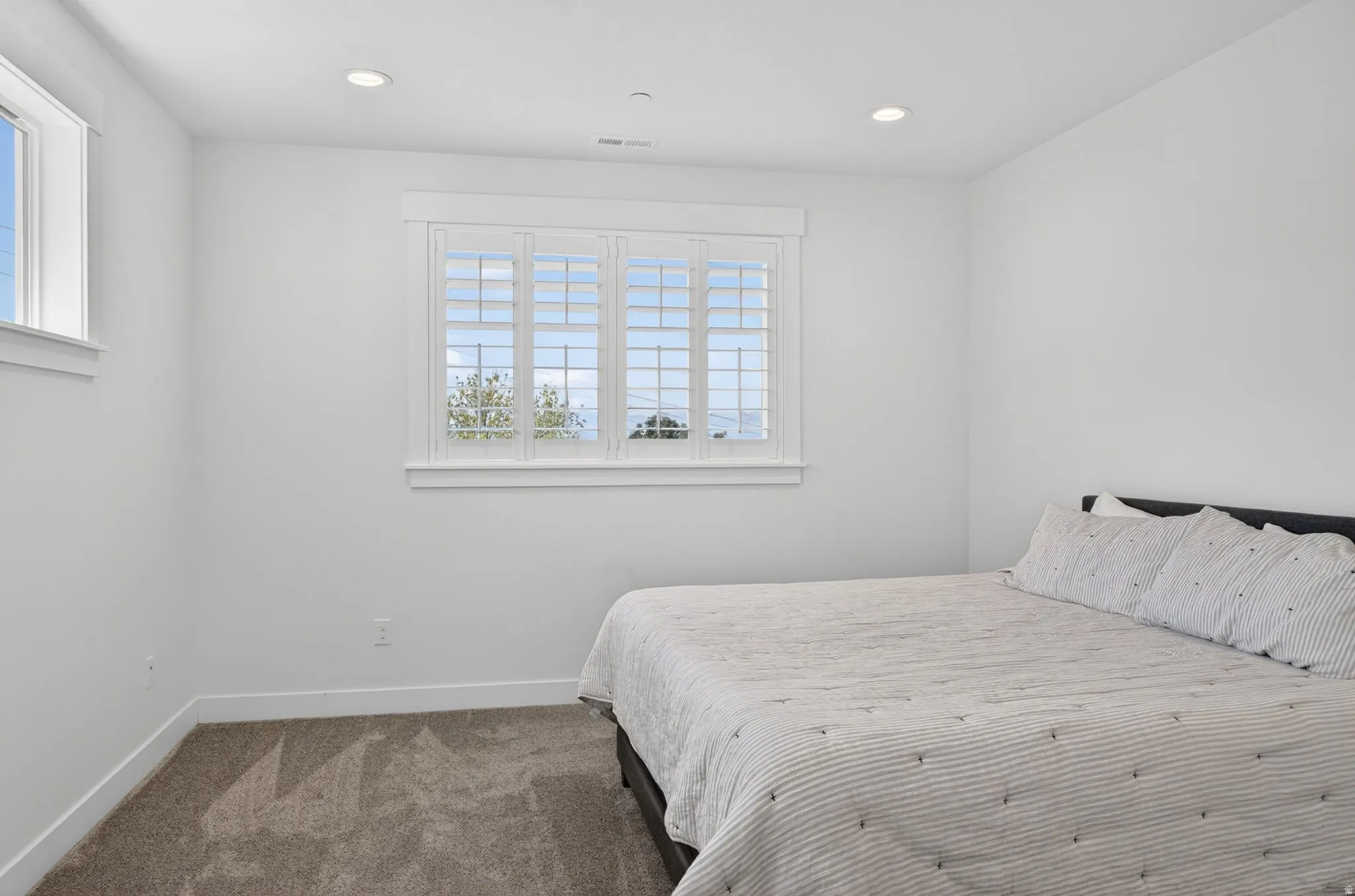 Room featuring neutral paint, recessed lighting, white baseboards, and carpet flooring