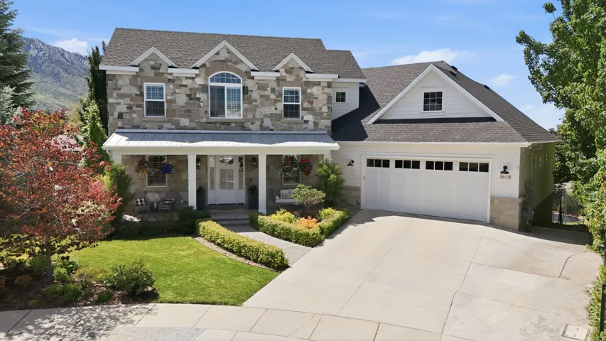 Stone and siding exterior with a prominent two-car garage