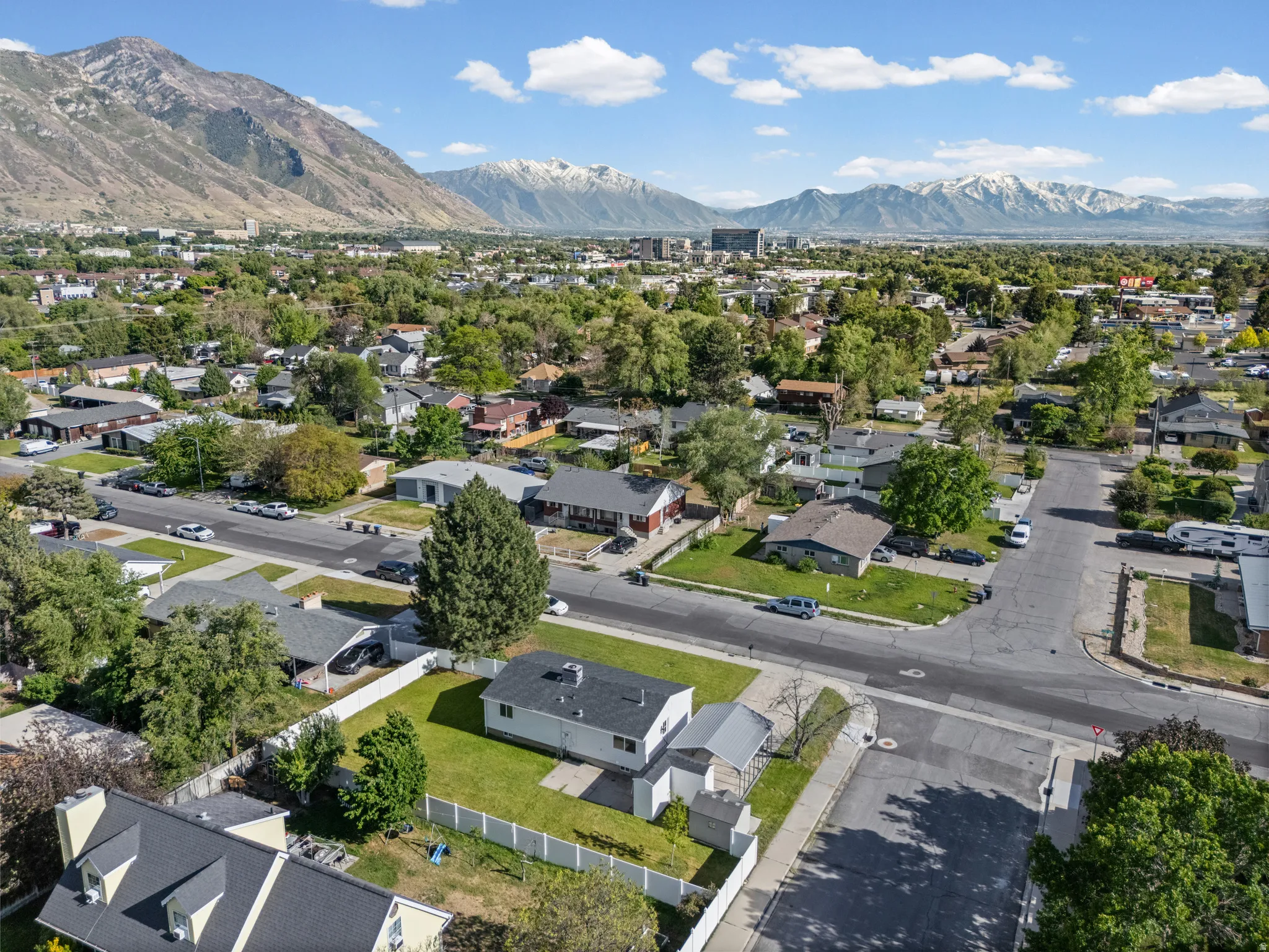Aerial perspective showcasing a residential neighborhood with a mountain backdrop