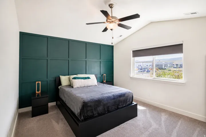 Accent wall with decorative paneling and a vaulted ceiling