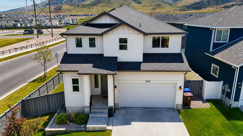 Modern two-story residence with white horizontal siding and dark trim