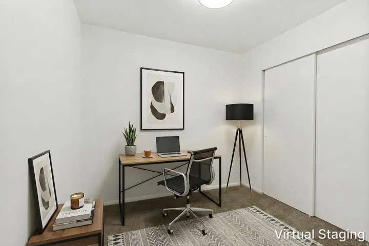 Light-colored walls defining a room with carpet flooring
