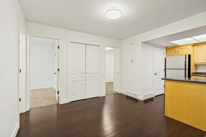 Dark wood-finish flooring extending through the primary space