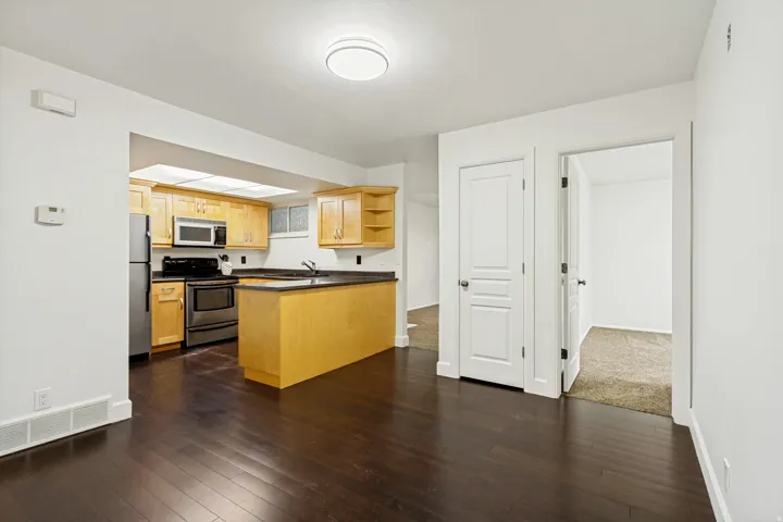 Kitchen featuring light wood cabinetry and stainless steel appliances